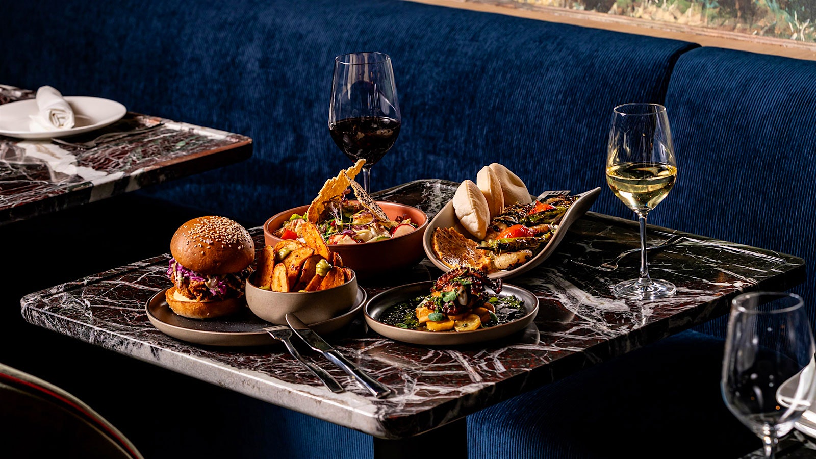 Dishes and glasses of wine from Ilili